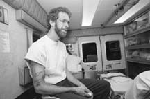 David Iverson sits in an ambulance after six young men beat him and stole $20 in St. Paul in 1995. "They came up and said, 'What's up?' The next thing I knew three of them were punching me." Ginger Pinson/Pioneer Press